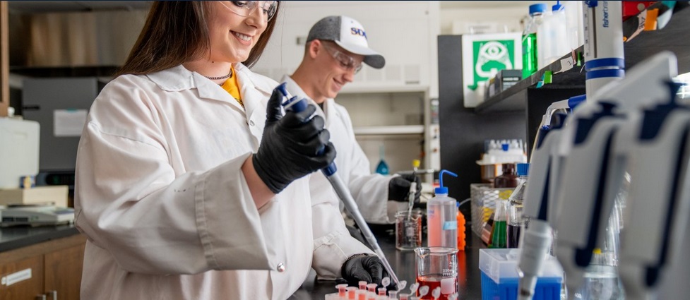 Two students working in a lab.